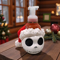 Soap bottle holder shaped like a white skull wearing a red Santa hat, on a wooden table with holiday greenery