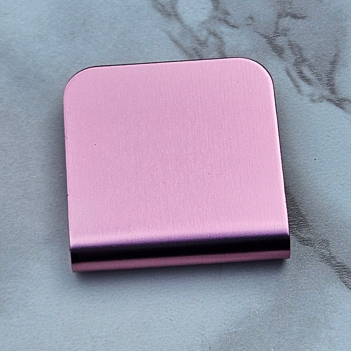 Pink magnetic hat clip with a removable golf ball marker