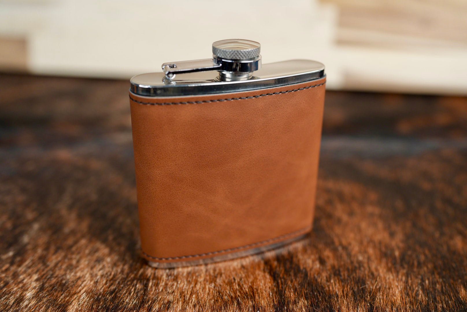 Walnut leatherette hip flask in a medium chocolate brown with a stainless steel cap