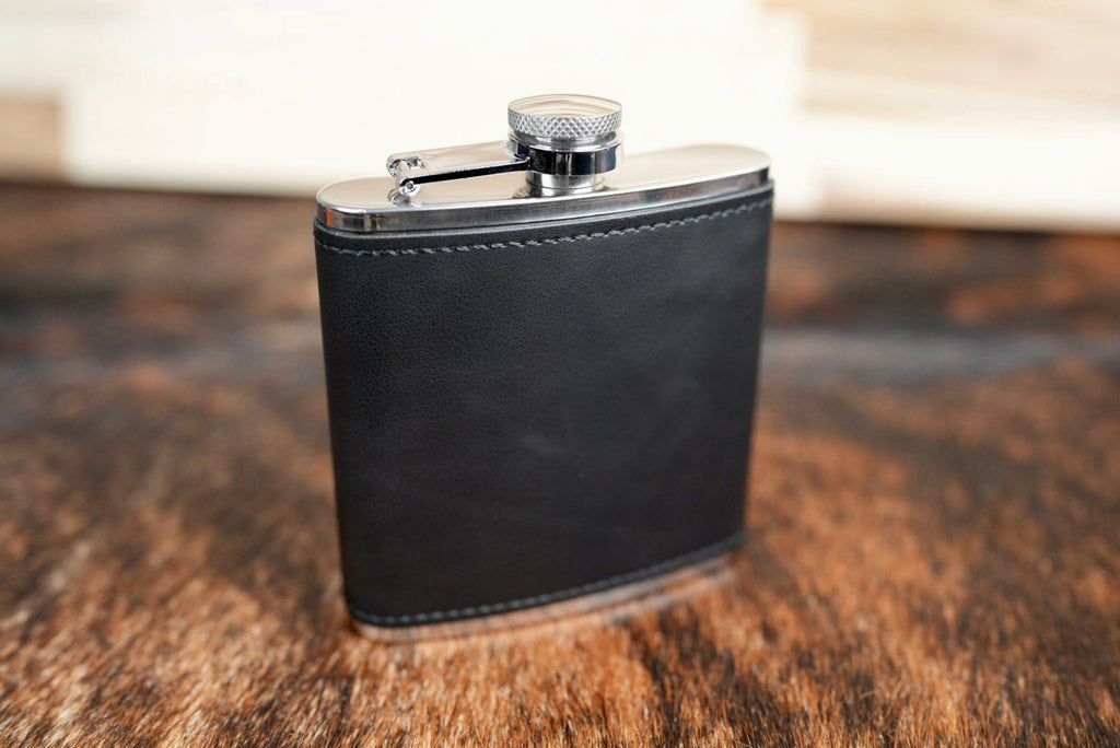 Heritage Black leatherette hip flask, solid black with black stitching and a stainless steel cap