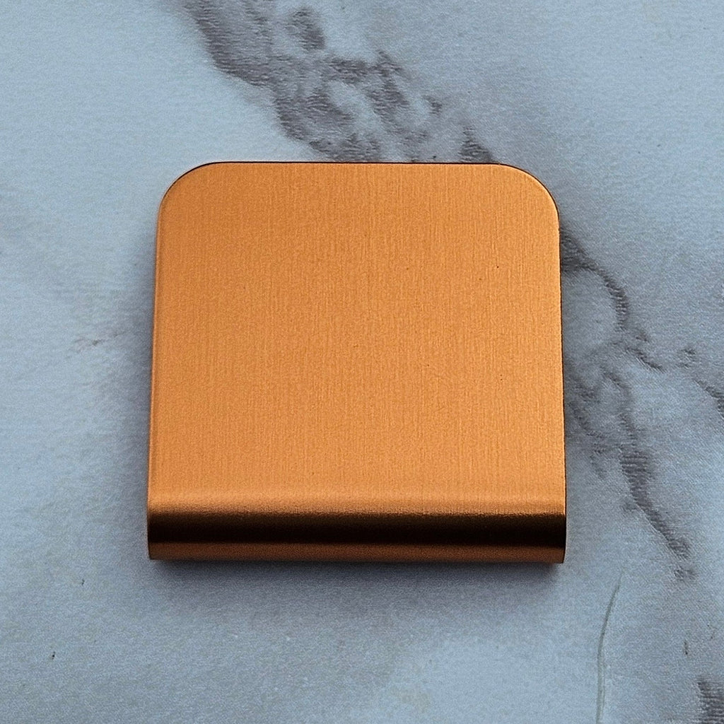 Orange magnetic hat clip with a removable golf ball marker