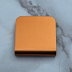 Orange magnetic hat clip with a removable golf ball marker