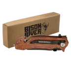 Wood-handled Bison River rescue knife with a belt clip, shown closed beside its kraft Bison River gift box