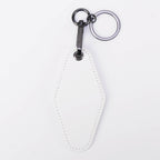 White leatherette motel keychain with a swivel clip and split ring