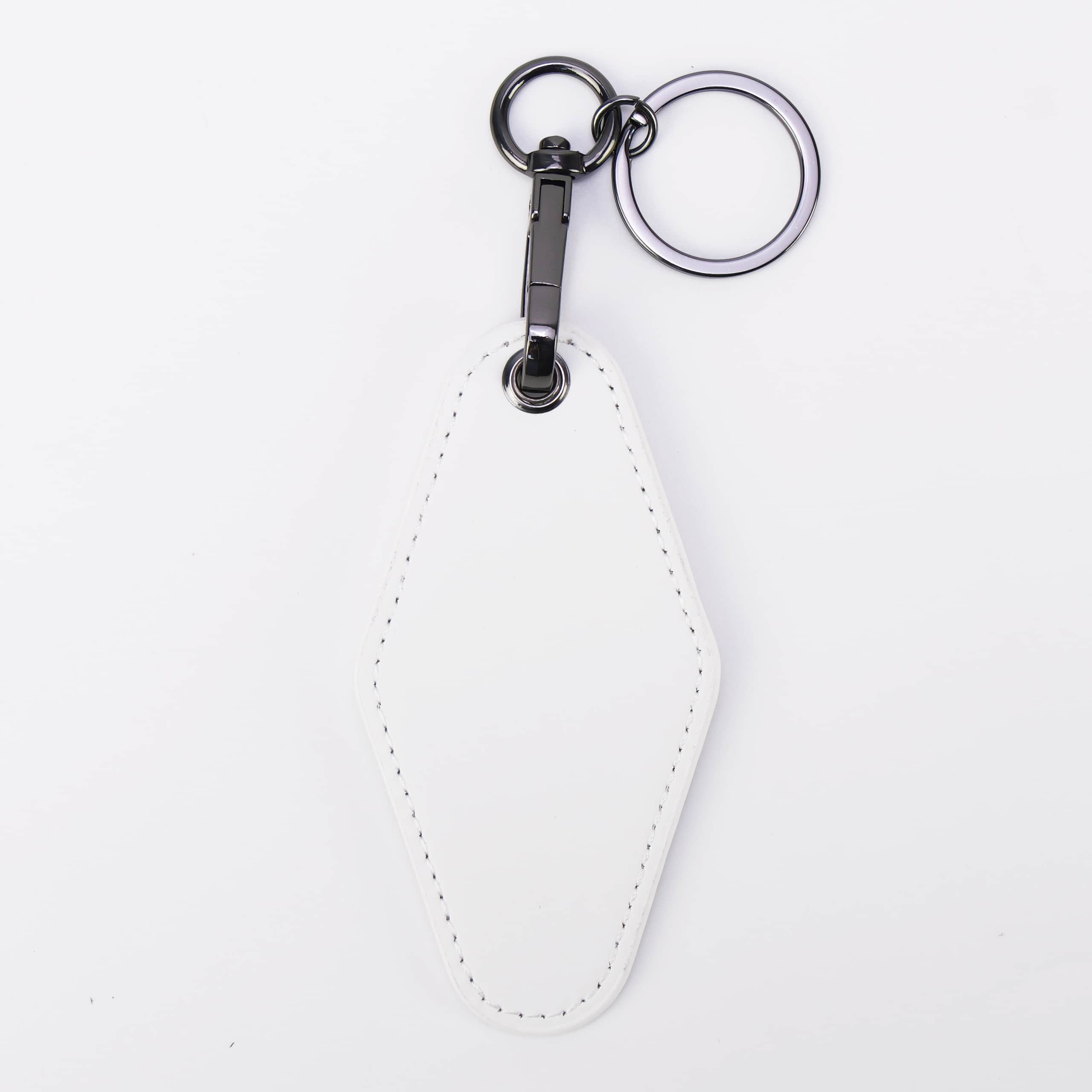 White leatherette motel keychain with a swivel clip and split ring