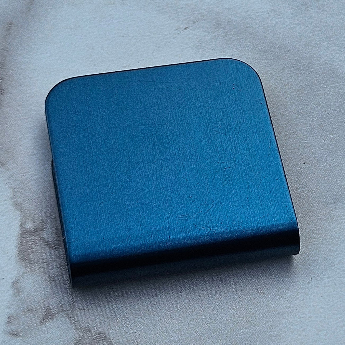 Steel blue magnetic hat clip with a removable golf ball marker