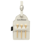 White leatherette golf bag tag with black backing and three wooden tees