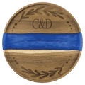 Round acacia serving tray with a blue pearl resin river and engraved monogram and wreath