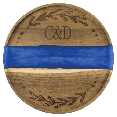 Round acacia serving tray with a blue pearl resin river and engraved monogram and wreath