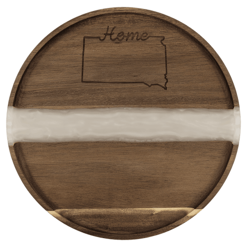 Round acacia serving tray with a white pearl resin river and engraved design on the wood