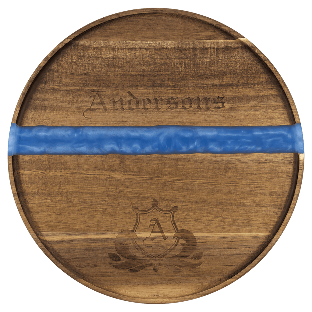 Large round acacia serving tray with blue pearl resin river and engraved family name and crest