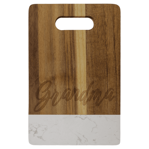 Small acacia cutting board with white marble band and cut-out handle, engraved on the wood