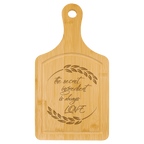 Bamboo paddle board engraved with a script quote about cooking with love