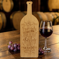 Bamboo cutting board cut in the shape of a wine bottle with a hanging hole in the neck
