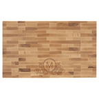 Maple butcher block engraved with an M monogram and flourish