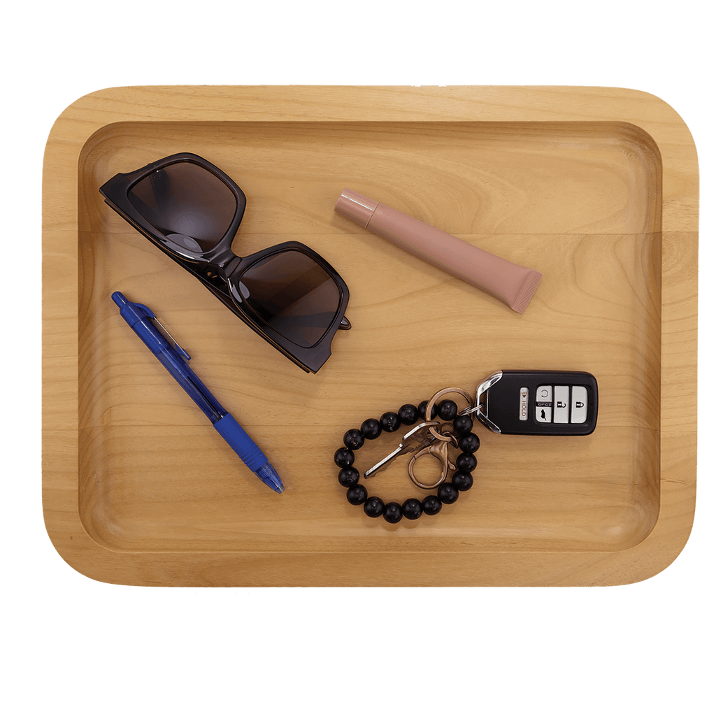 Alder tray holding sunglasses, a pen, keys and a bracelet