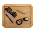 Alder tray holding sunglasses, a pen, keys and a bracelet