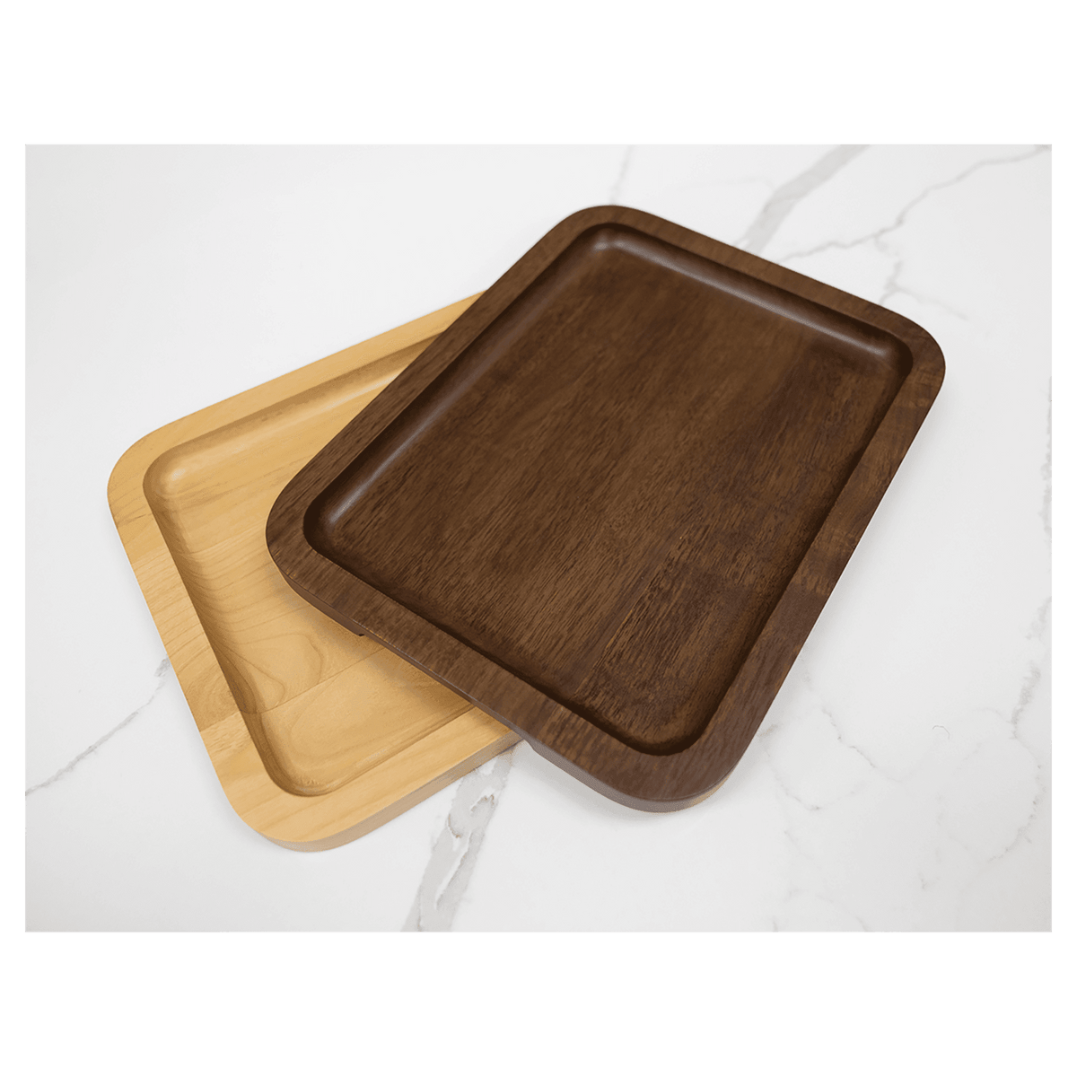 Walnut tray stacked on an alder tray on a marble counter
