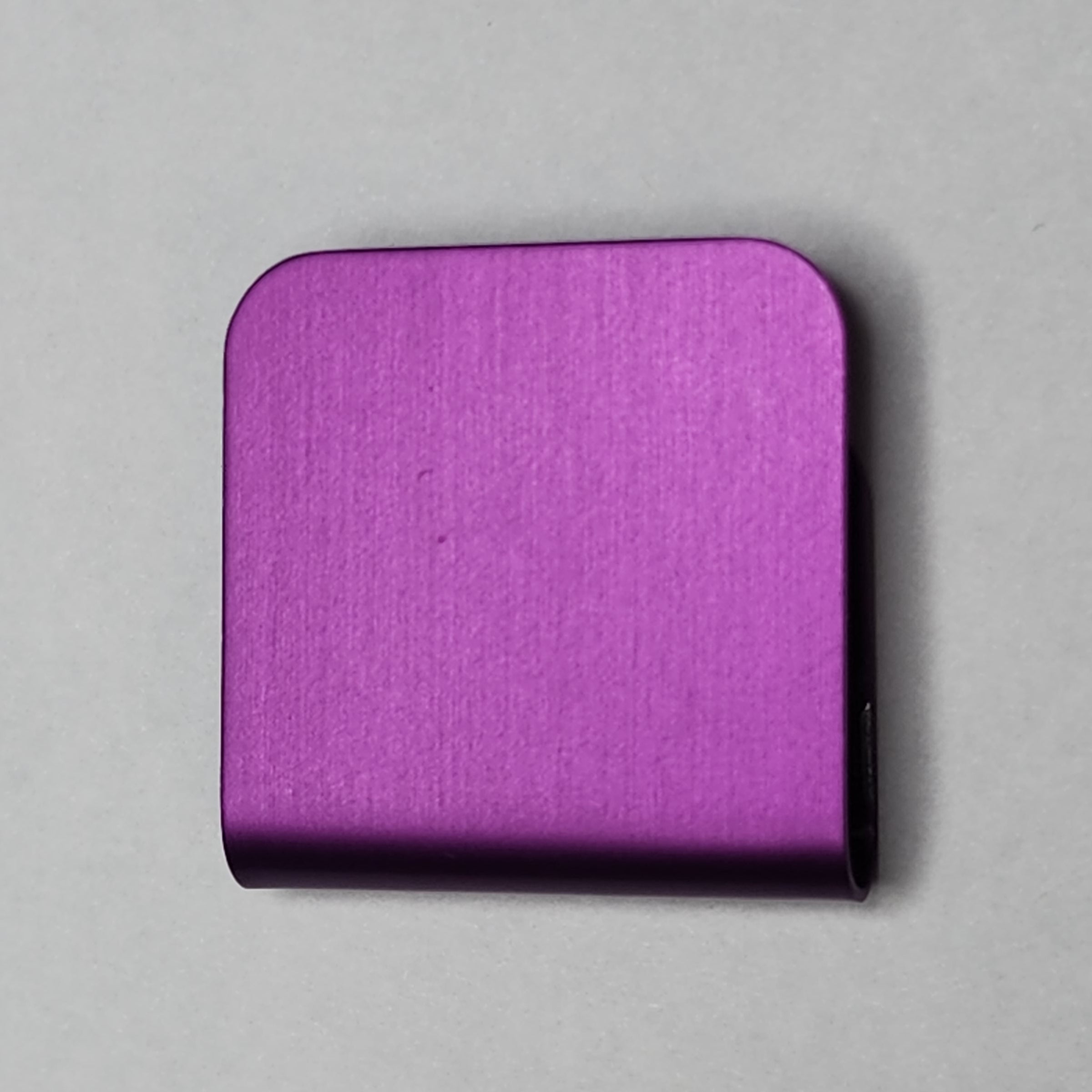 Magenta magnetic hat clip with a removable golf ball marker