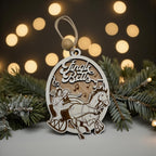 Wooden oval ornament engraved with a Jingle Bells scene, hanging against warm out-of-focus lights
