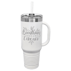 White powder-coated 40 oz. travel mug with a handle, straw and snap lid, shown with a sample engraving