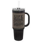 Black 40 oz. travel mug with a gray leatherette wrap, handle, straw and snap lid, shown with a sample engraving