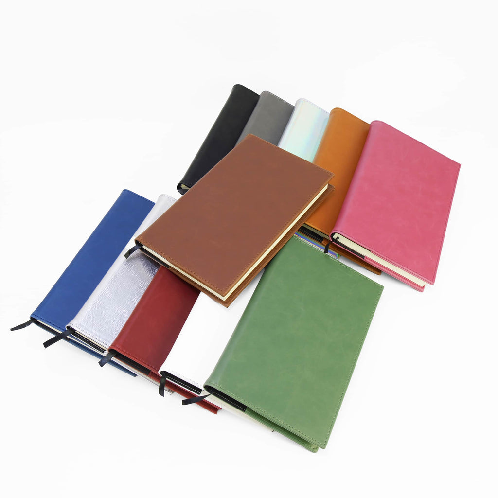 All twelve journal colors laid out overlapping, including holographic, metallic gold and metallic silver