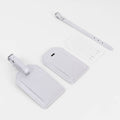 White leatherette luggage tag with its buckle strap and address card