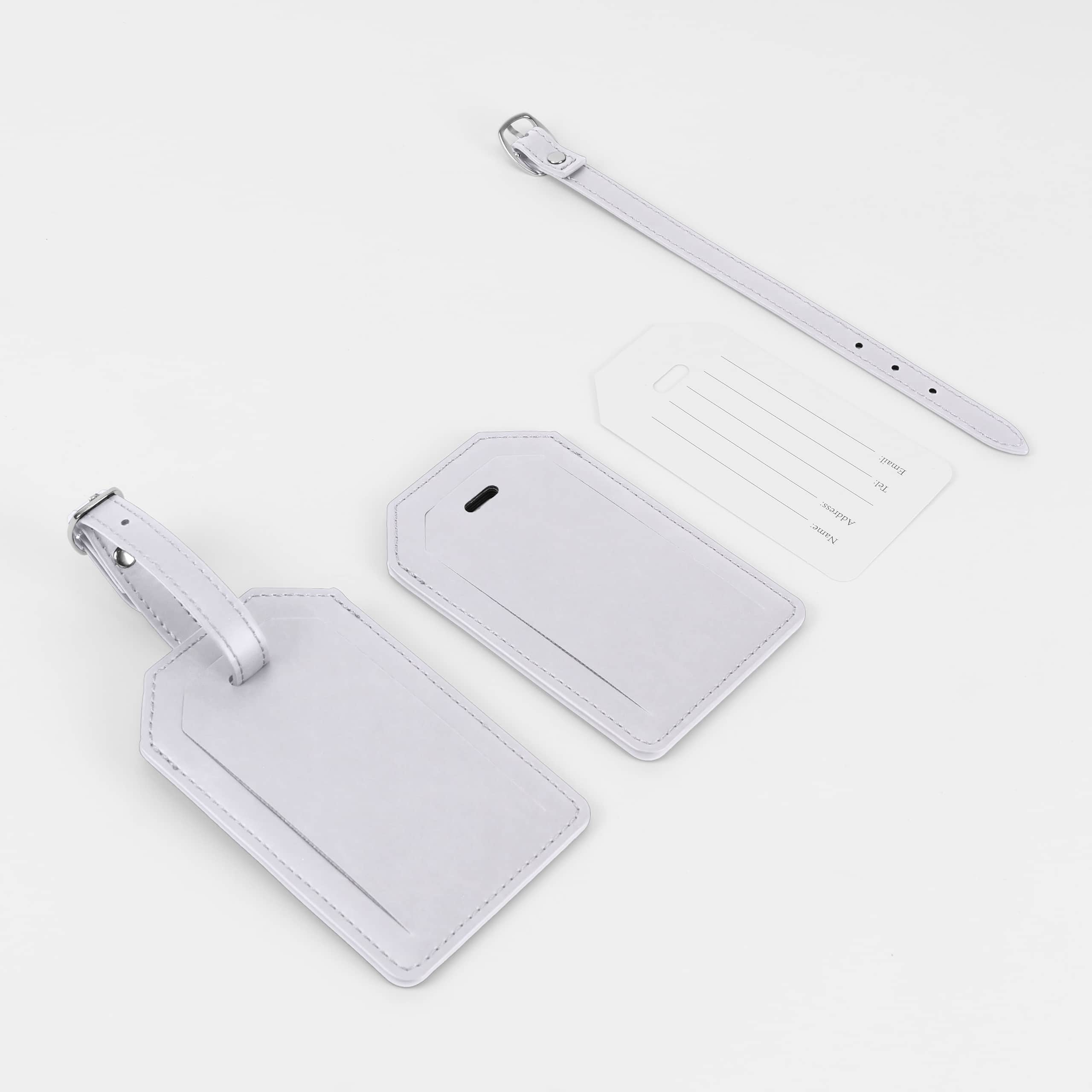 White leatherette luggage tag with its buckle strap and address card