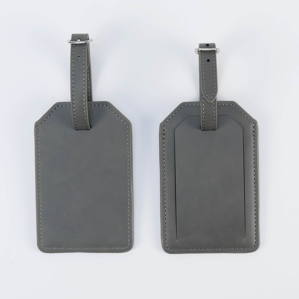 Gray leatherette luggage tag, front and back, with buckle strap
