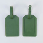 Sage green leatherette luggage tag, front and back, with buckle strap