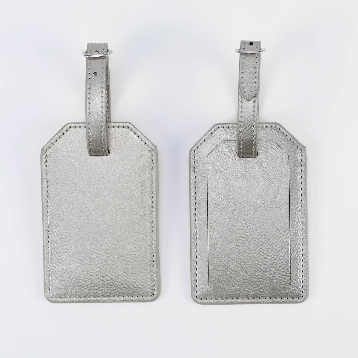 Metallic silver leatherette luggage tag, front and back, with buckle strap