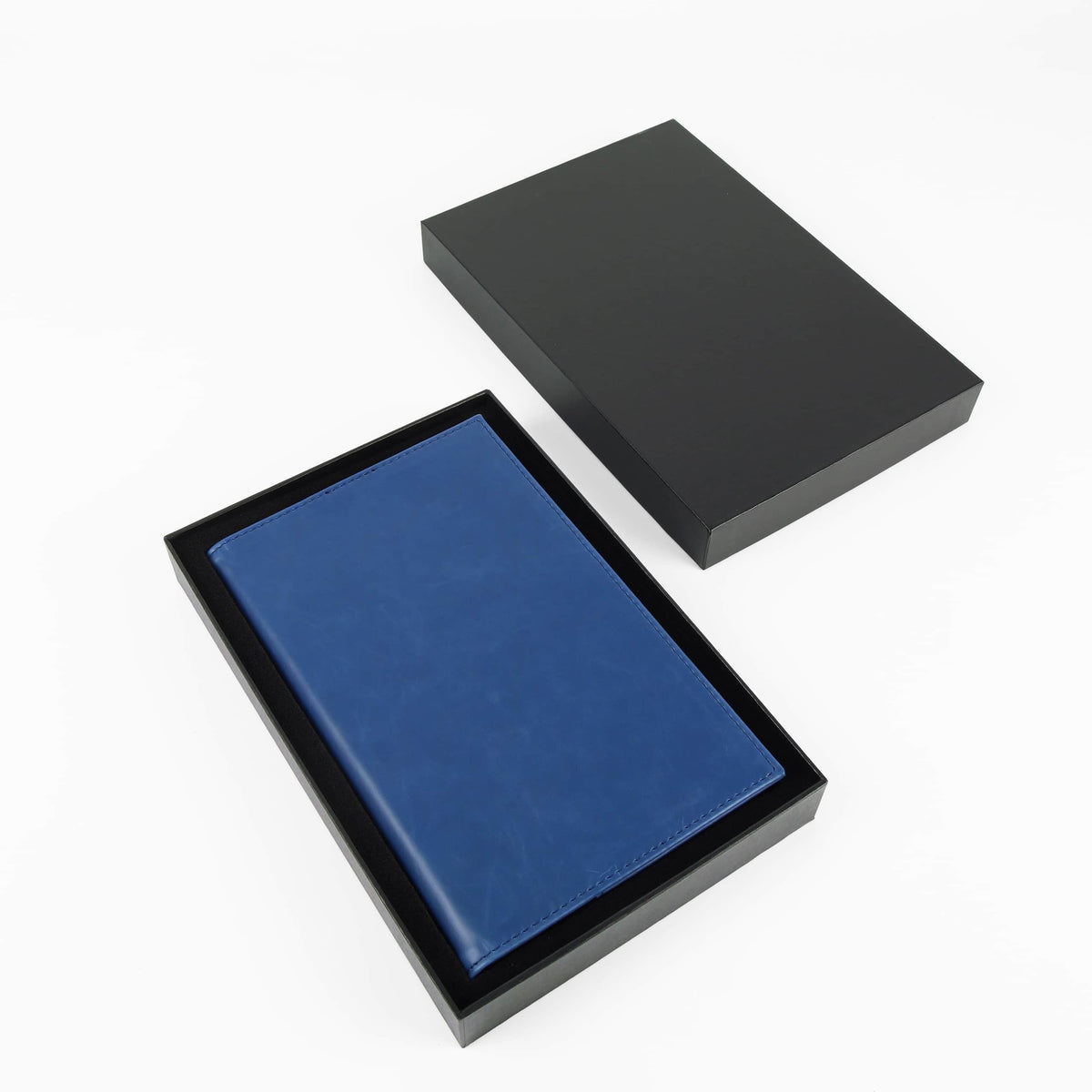 Navy blue leatherette journal in its open black gift box