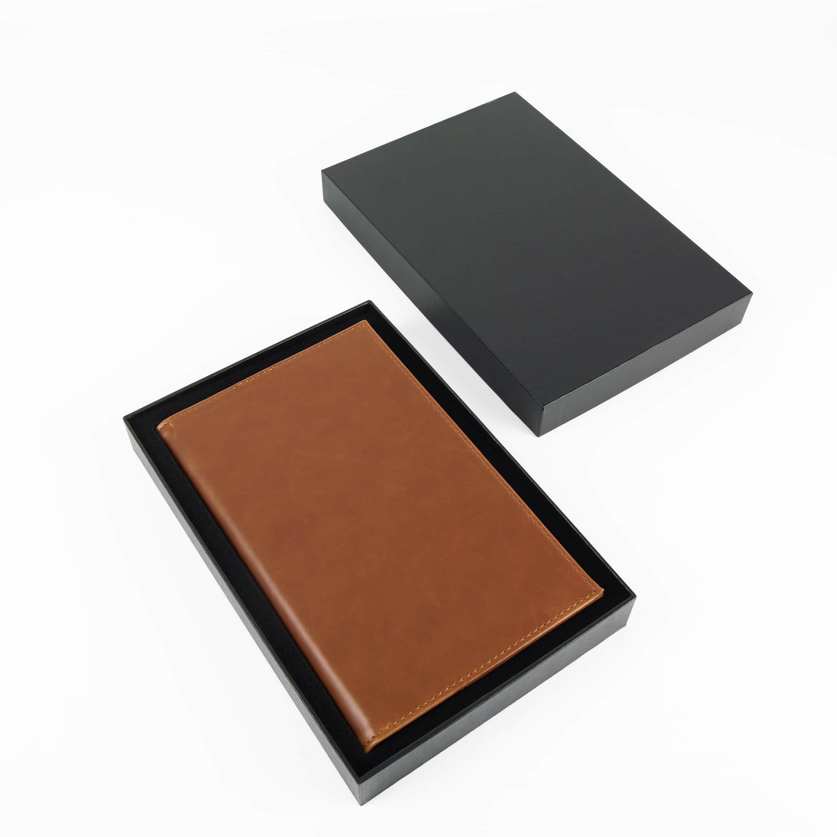 Brown leatherette journal in its open black gift box