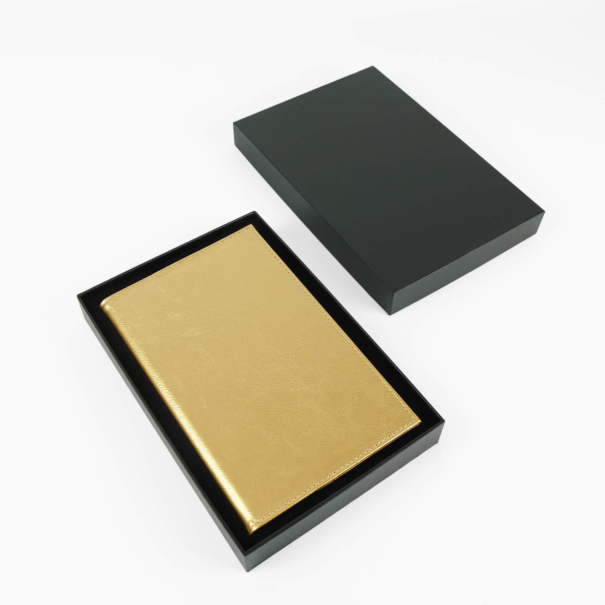 Metallic gold leatherette journal in its open black gift box
