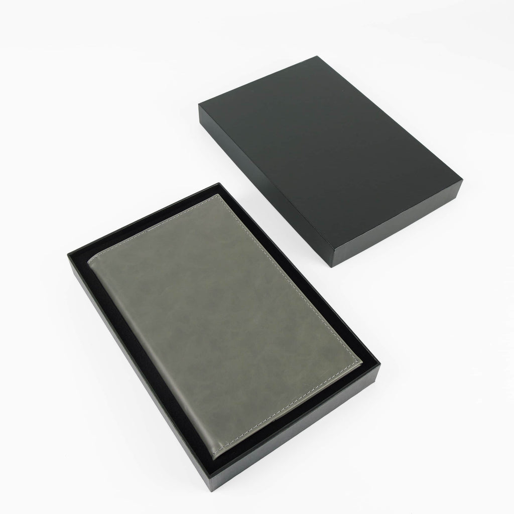 Gray leatherette journal in its open black gift box