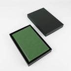 Sage green leatherette journal in its open black gift box