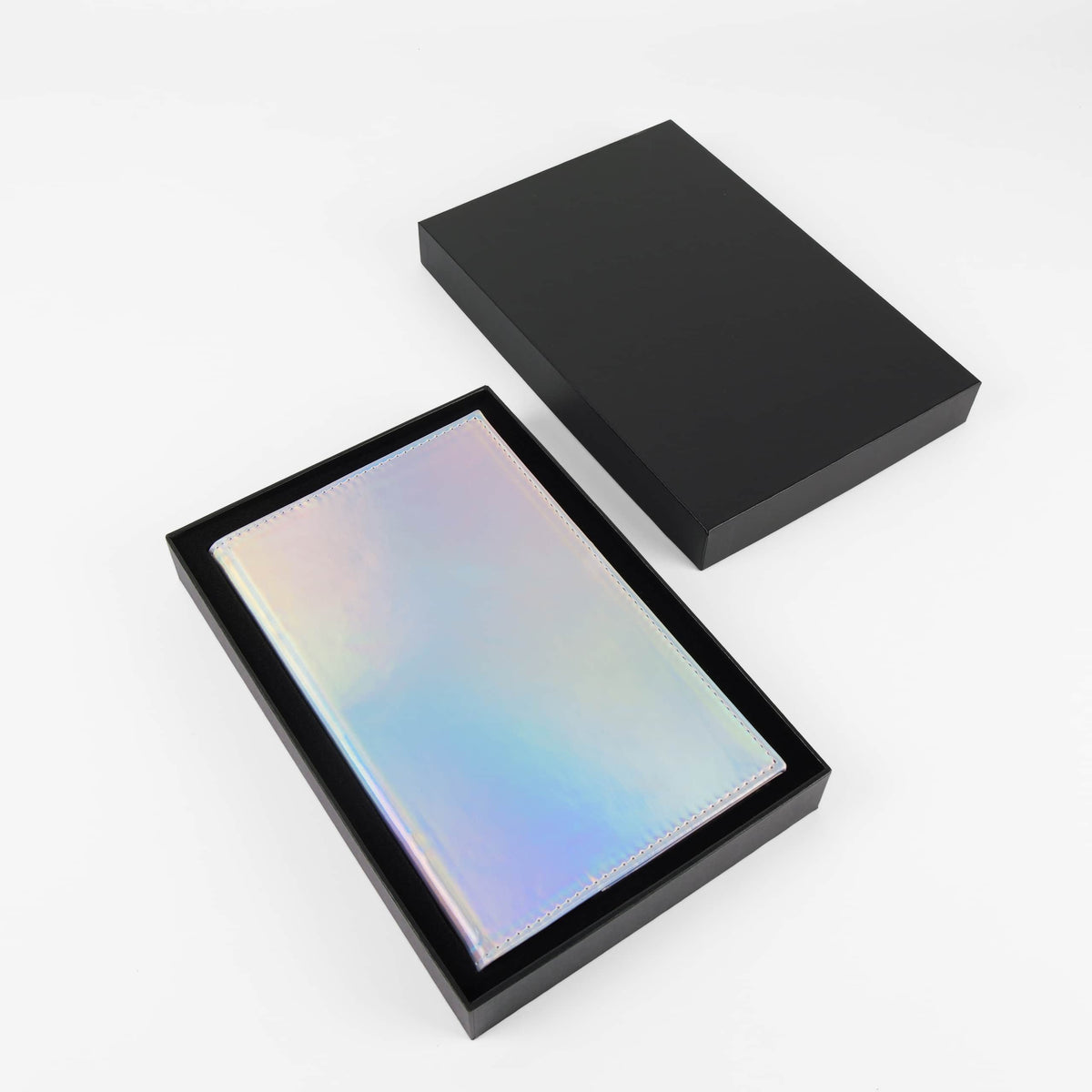 Holographic iridescent leatherette journal in its open black gift box