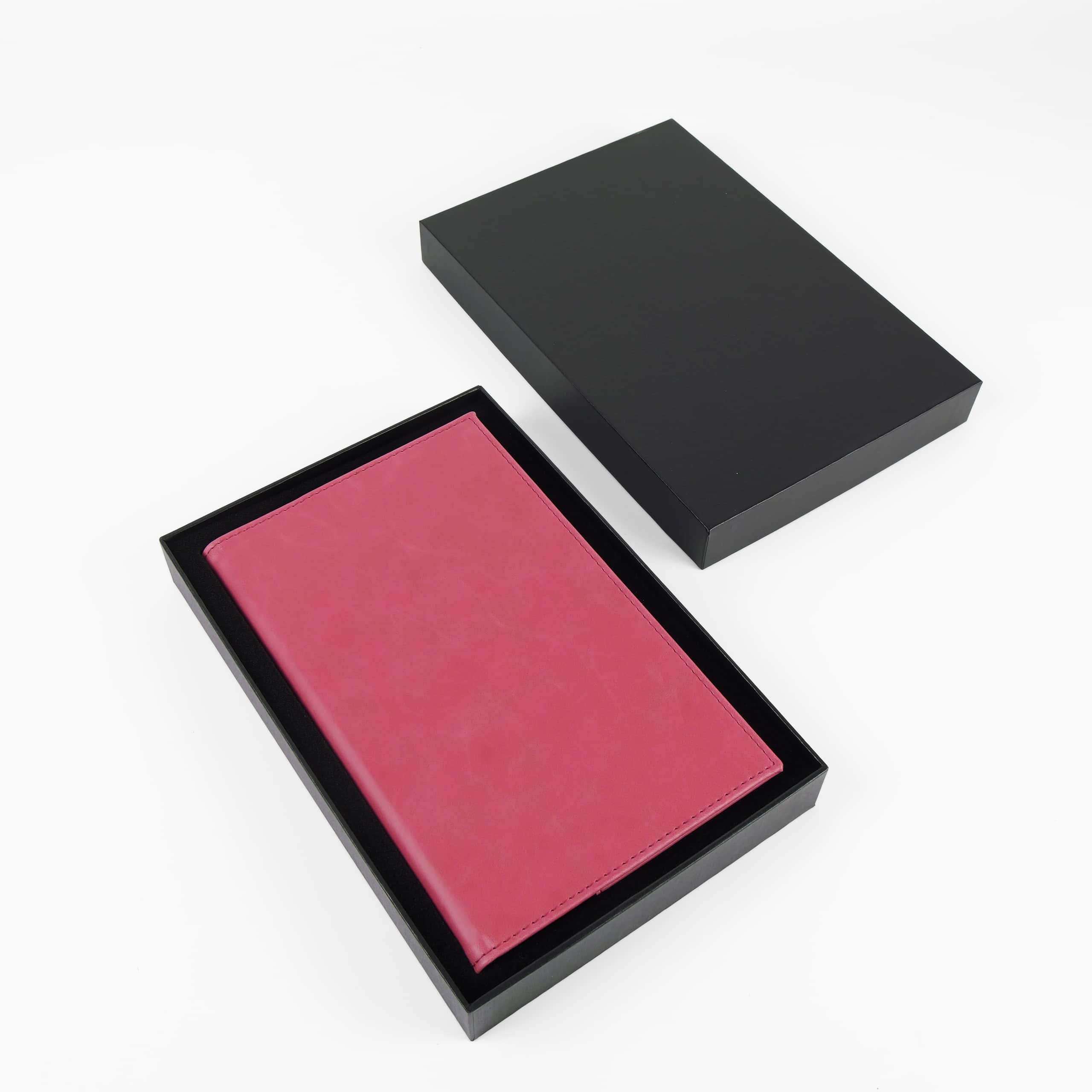 Pink leatherette journal in its open black gift box