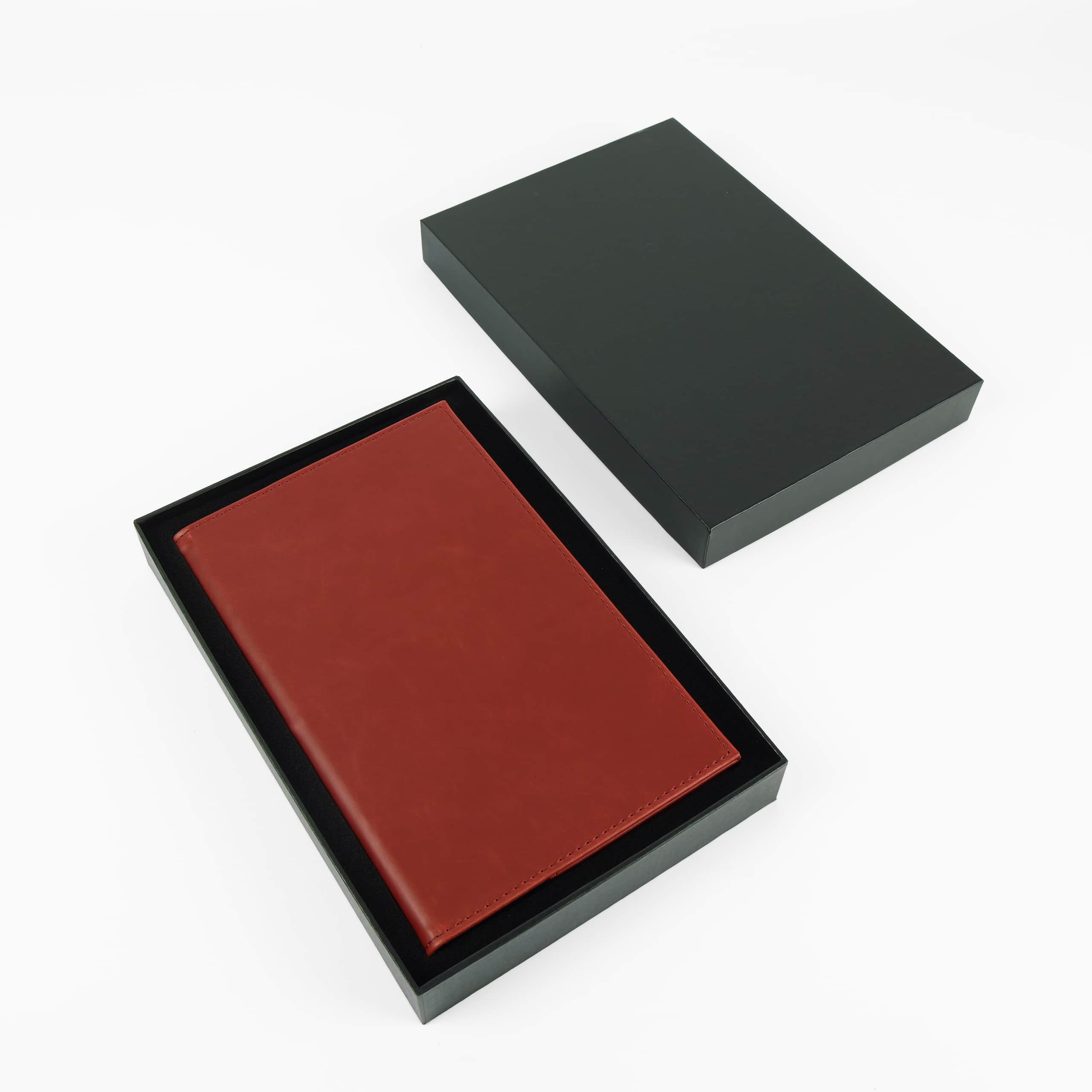 Red leatherette journal in its open black gift box