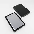 Metallic silver leatherette journal in its open black gift box