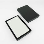 White leatherette journal in its open black gift box