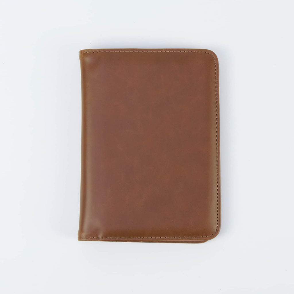 Brown leatherette passport wallet, closed front view