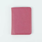 Pink leatherette passport wallet, closed front view