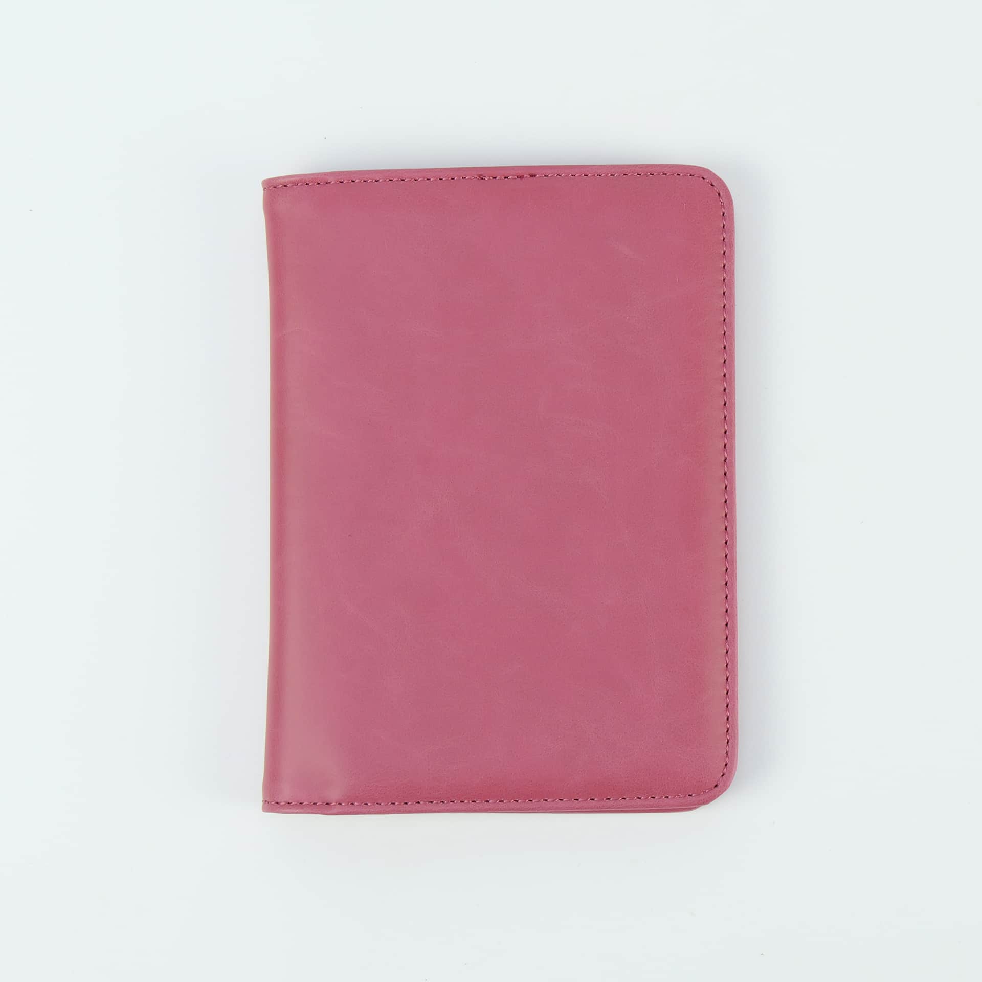 Pink leatherette passport wallet, closed front view