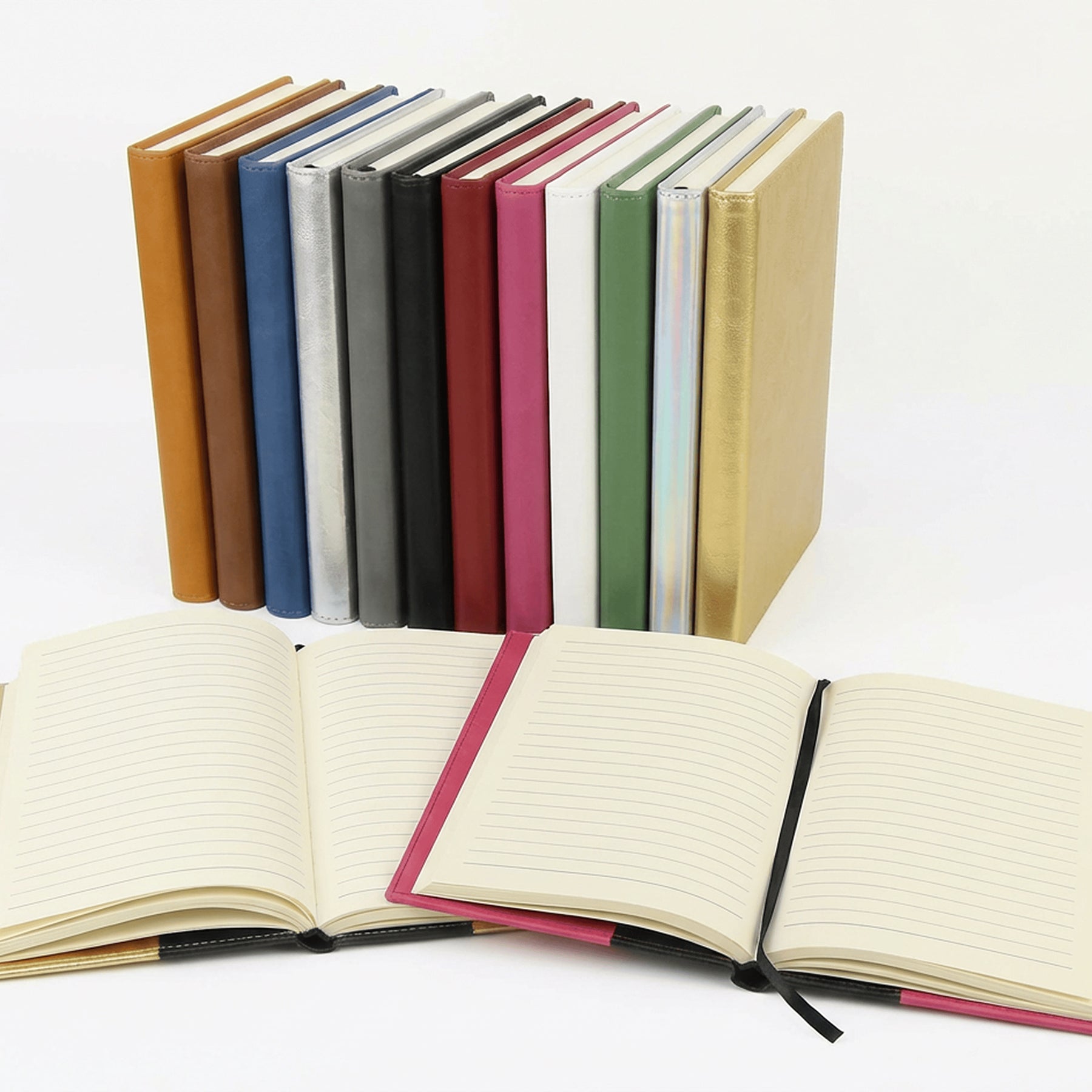 Journals in several colors with two opened flat to show the cream lined pages and ribbon bookmark