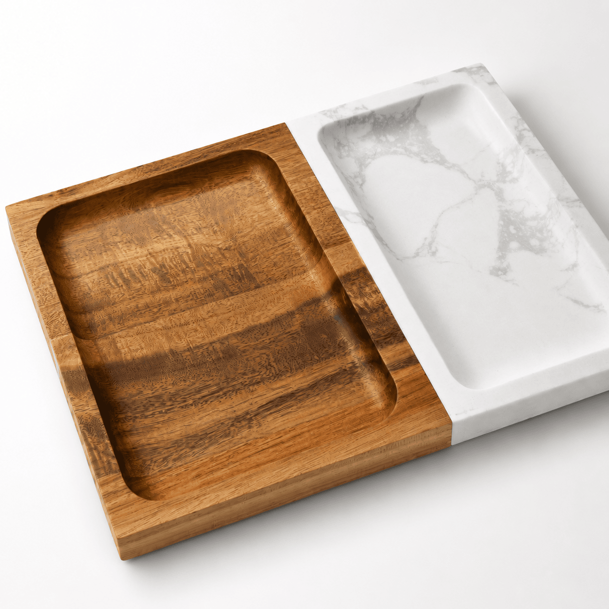 Marble and acacia wood valet tray shown at an angle, wood side with a deep recessed compartment beside the white marble side