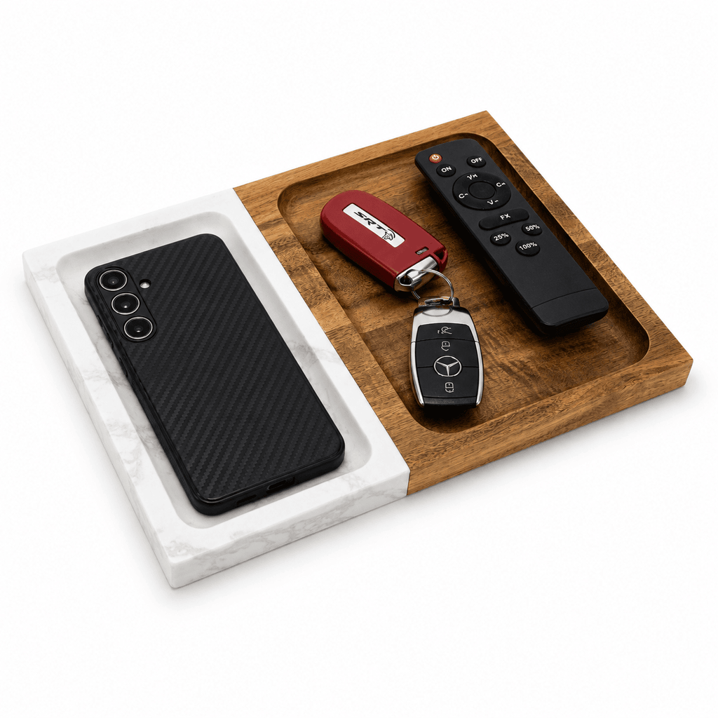 Marble and wood valet tray holding a phone, car key fob and remote in its recessed compartments