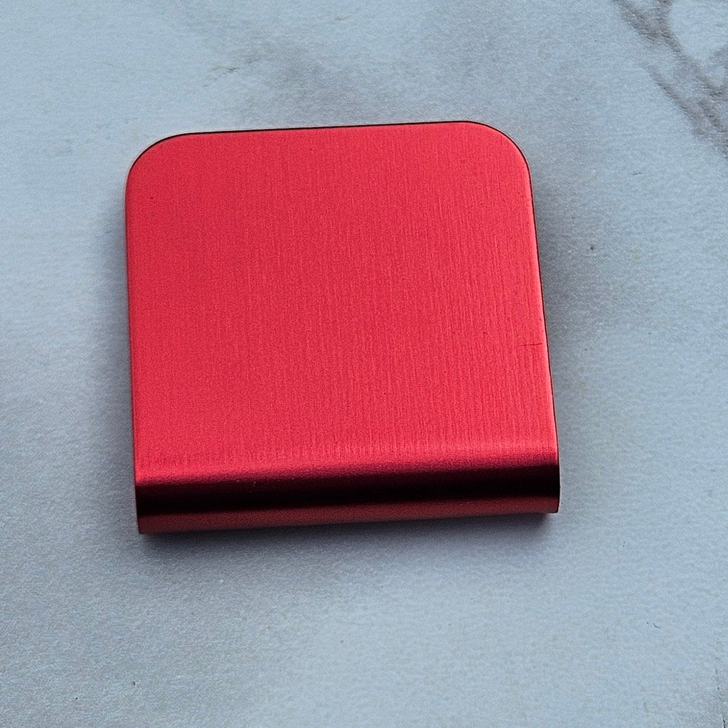 Red magnetic hat clip with a removable golf ball marker