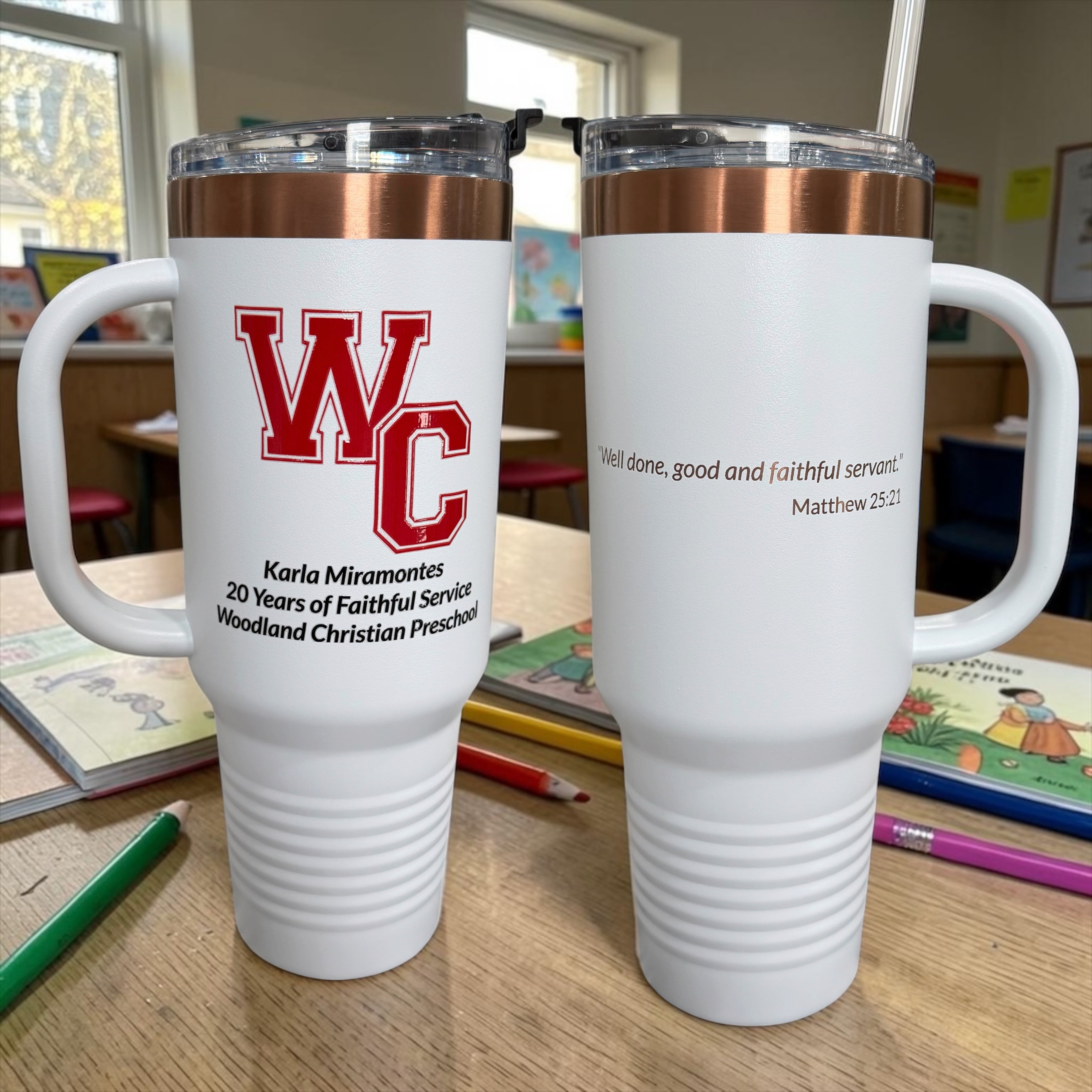Two white travel mugs with copper rims, one engraved with a red letter "W" monogram